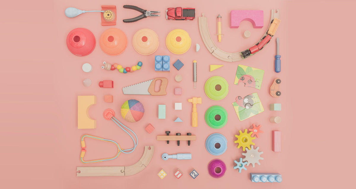 assortment of toys on pink