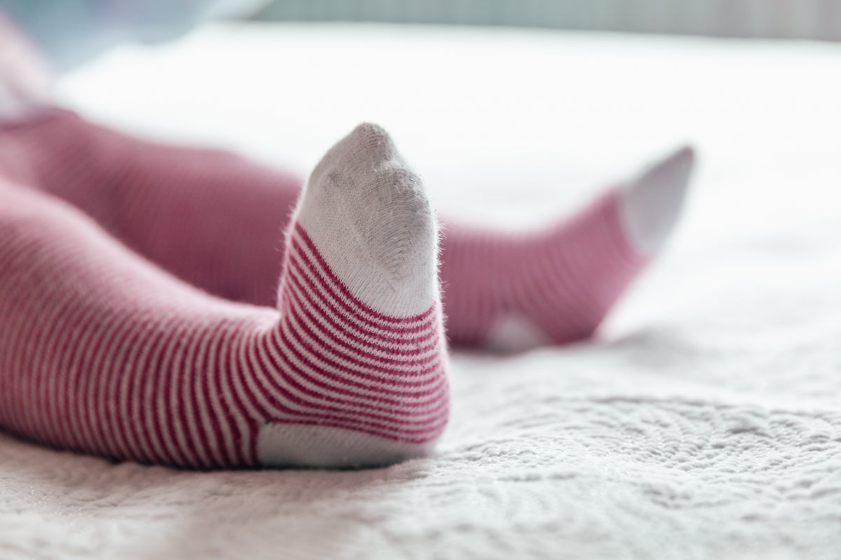 baby feet in striped socks