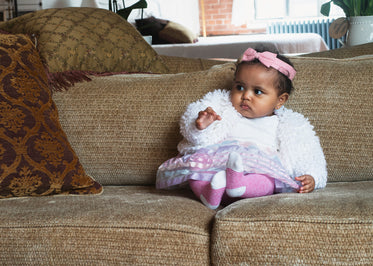 baby leaning on couch