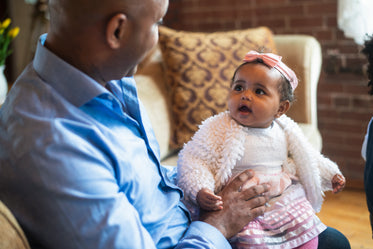 baby looks at father