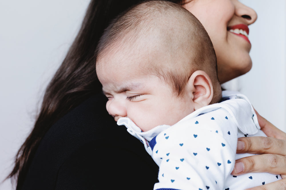 baby rests on mothers shoulder