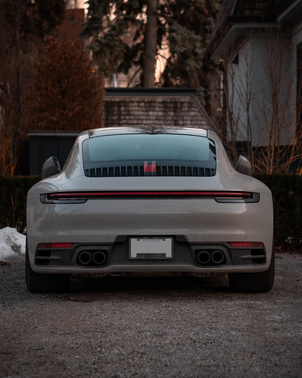 back of a grey sports car with red detail