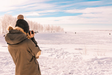back of person taking a photo of a winter day