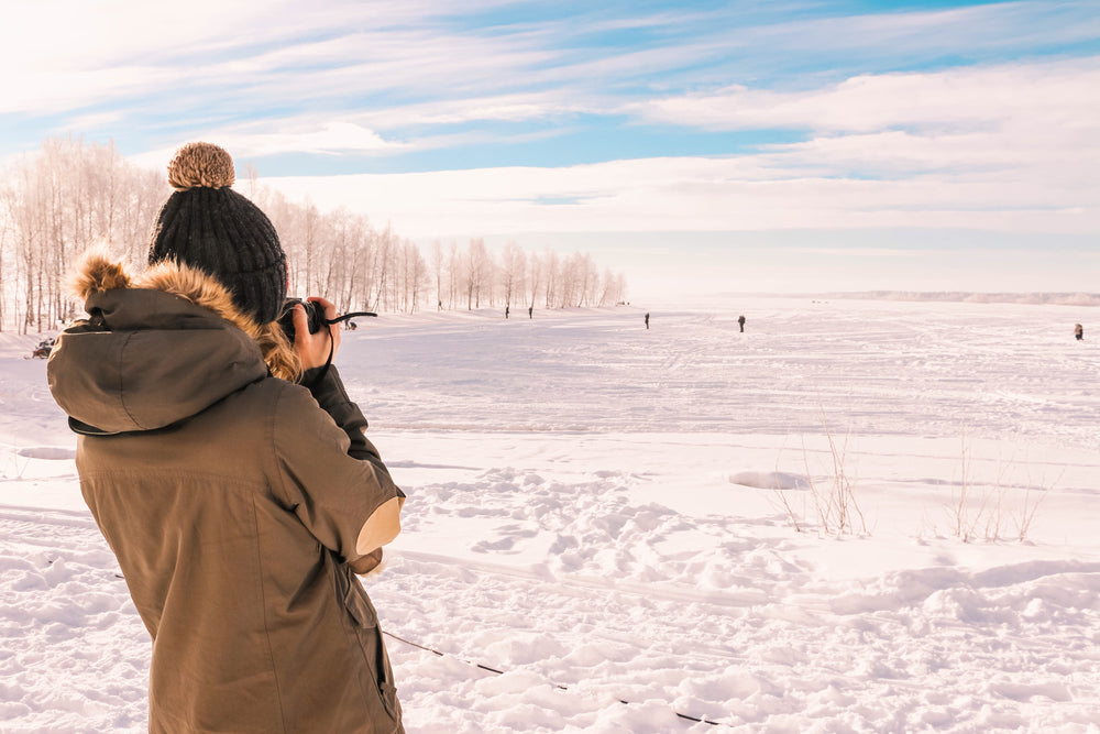 back of person taking a photo of a winter day