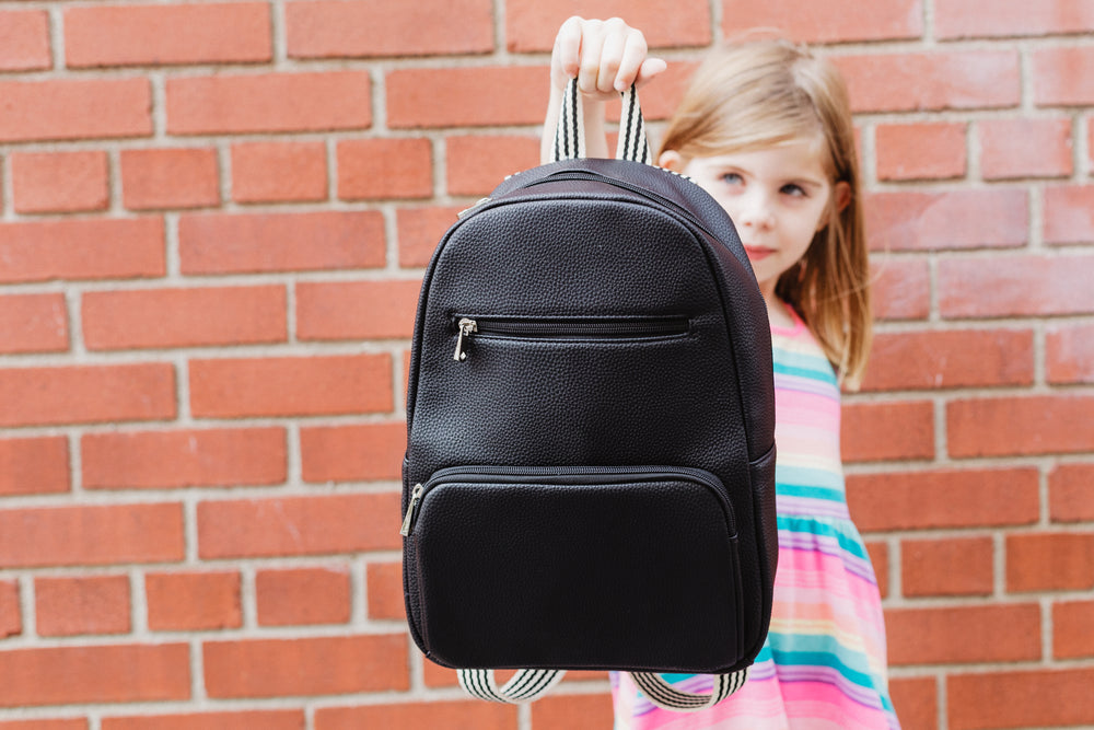 back to school holding out backpack