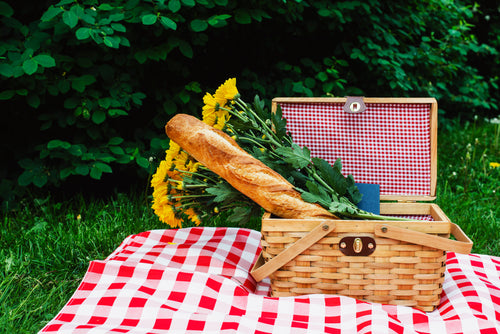 baguette and flowers in picnic basket