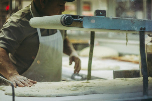 baker kneading out dough