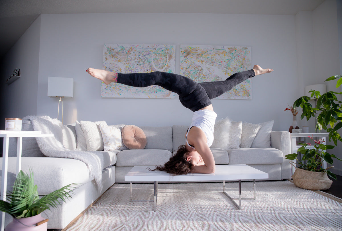 balancing on their head on a coffee table