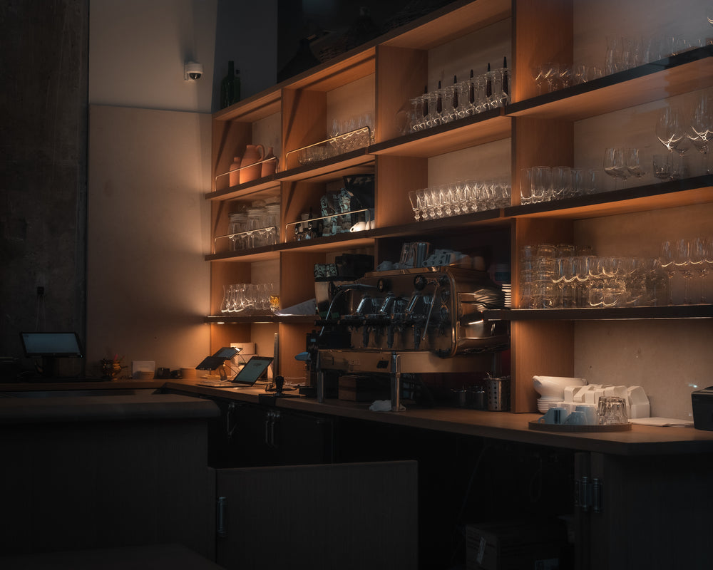bar filled with glassware and an espresso machine
