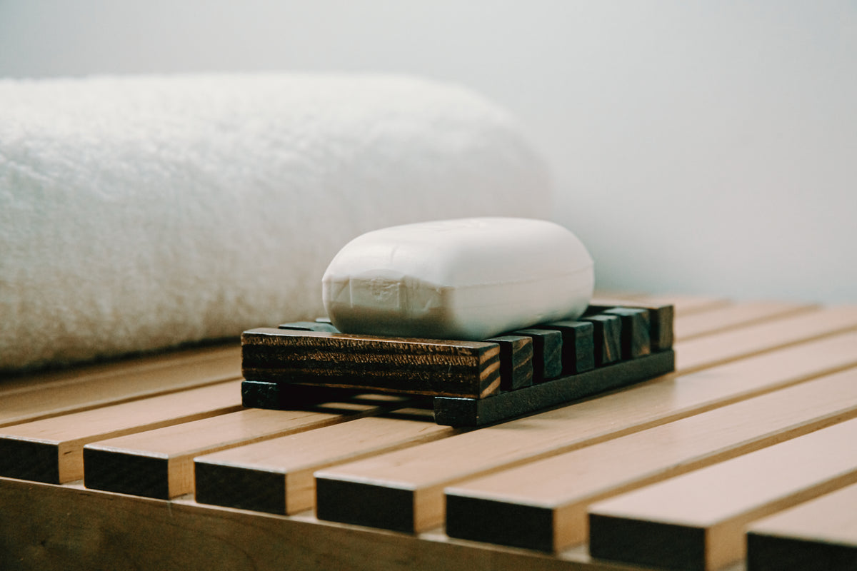 bar of white soap on a wooden holder