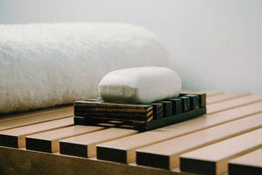 bar of white soap on a wooden holder