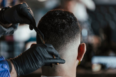 barber adds final touches to a haircut