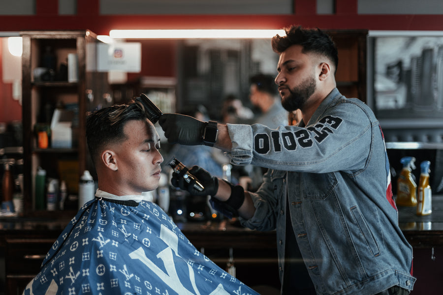 Barber brushes and cuts hair