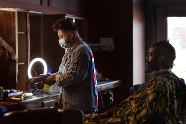 barber gets organized as the customer waits behind him