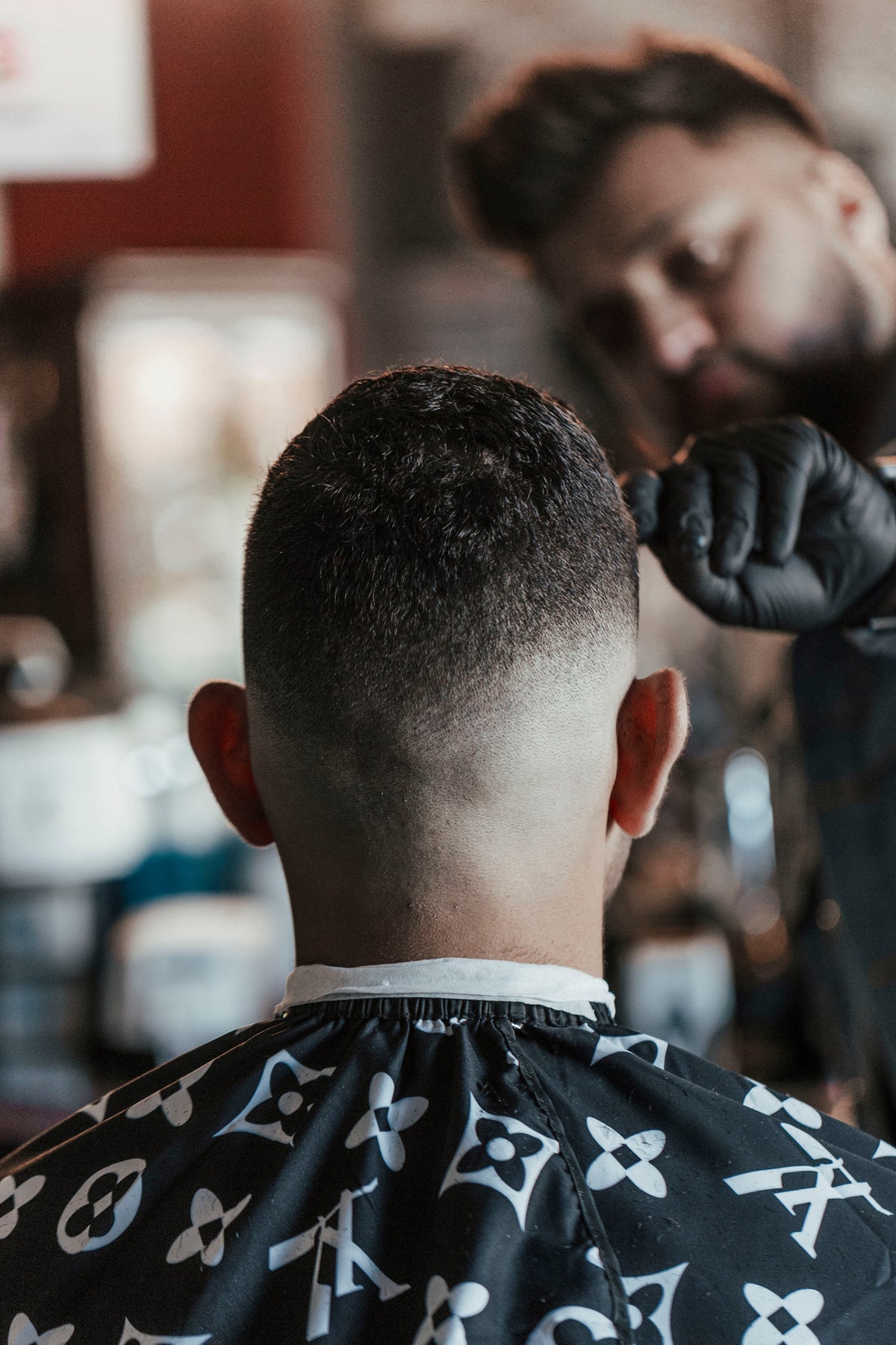 barber inspects his work of a clean haircut