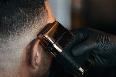 barber shaves side of persons head