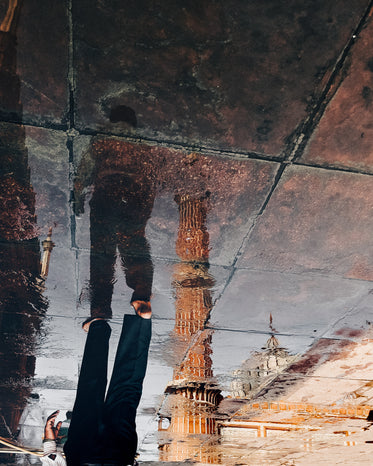 bare feet walk over wet paving stones