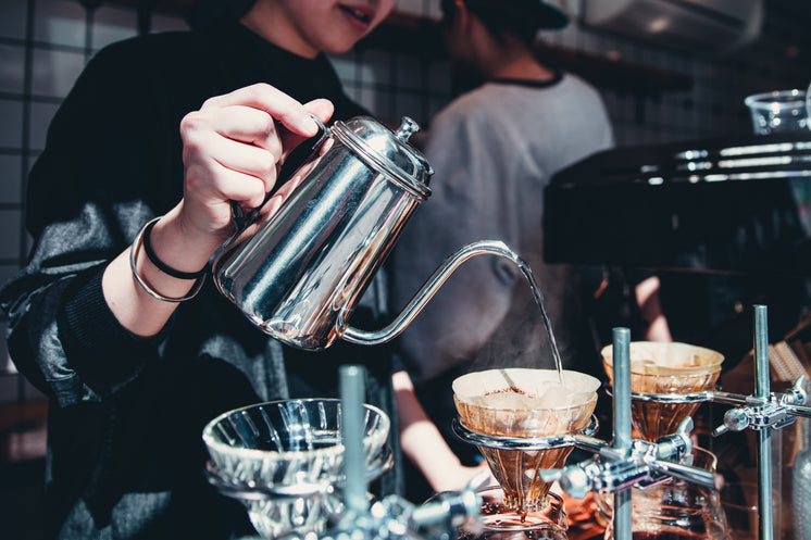 Barista Pours Over Coffee At Cafe