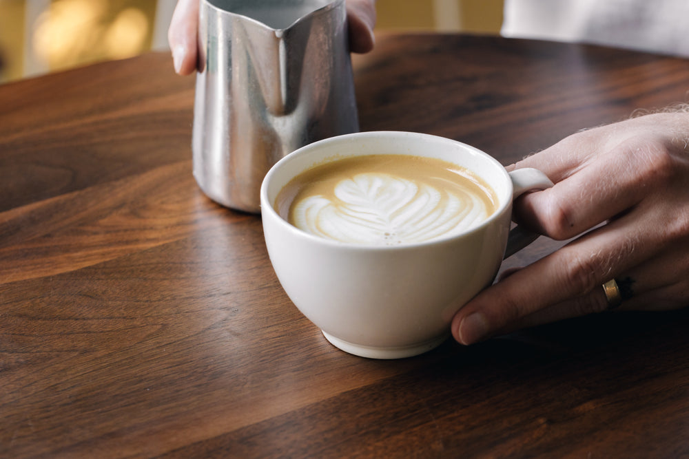 barrista holding latte