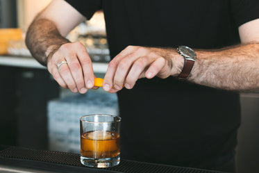 bartender adding twist to drink