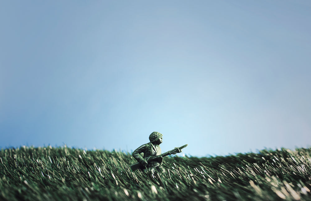 battling soldier toys in grass