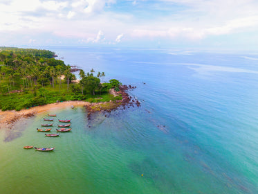 beach scene with canoes sat by shore