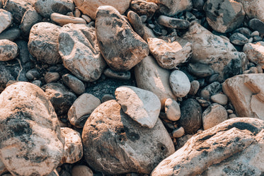 beach stones rounded by waves cover the shore