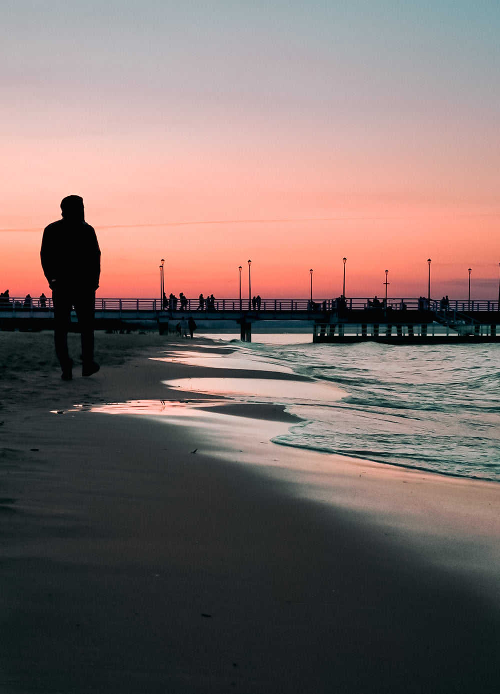 beach walk at sunset with a pier in the distance