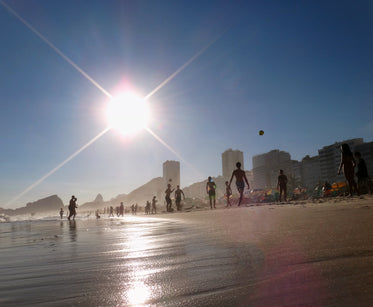 beach with people playing in the sunshine