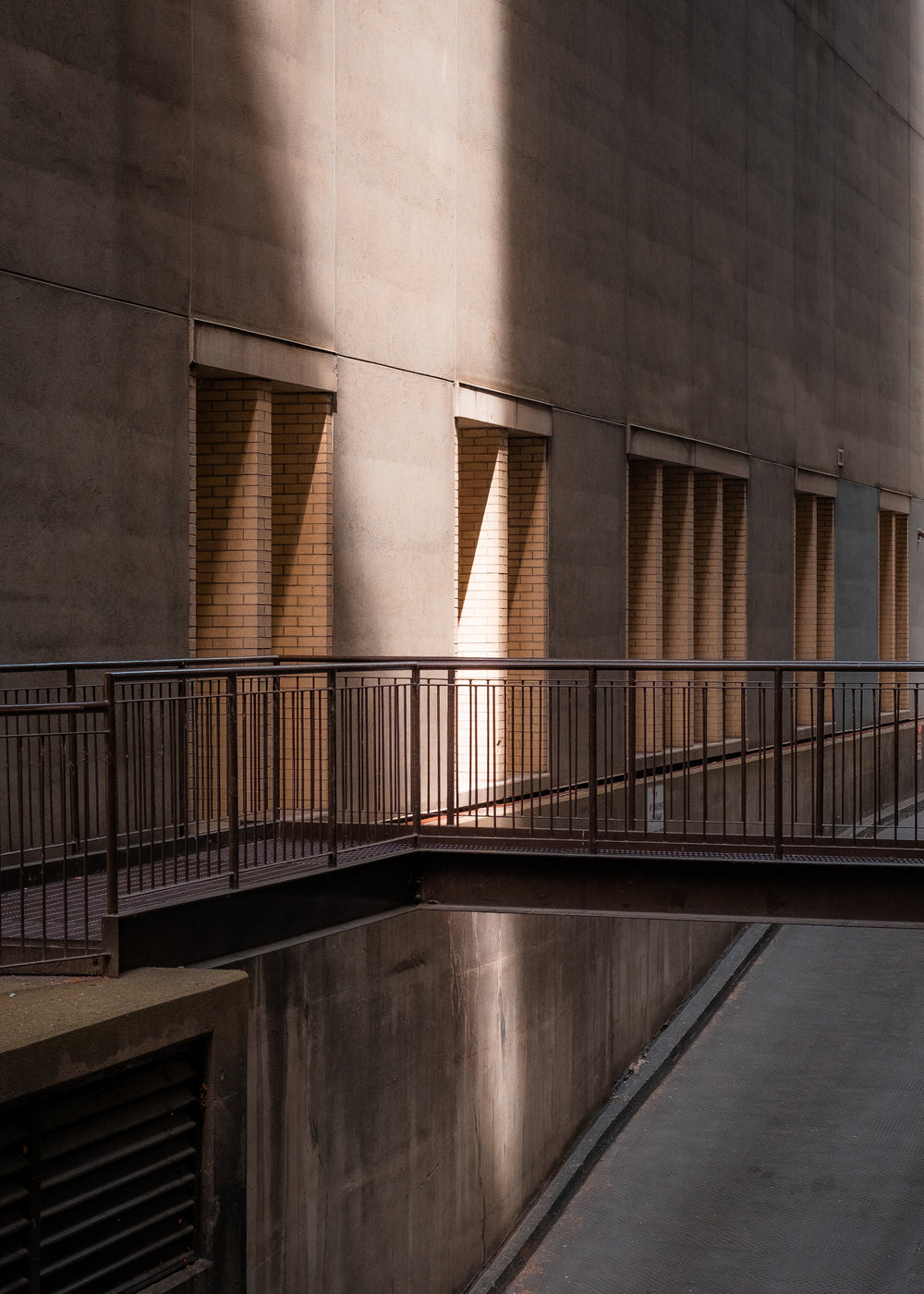 beam of late afternoon sunlight on the side of a building