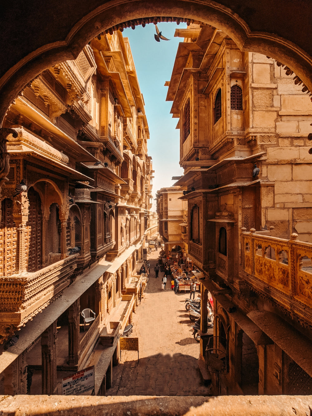 beautiful city street with stone building and carved balconies