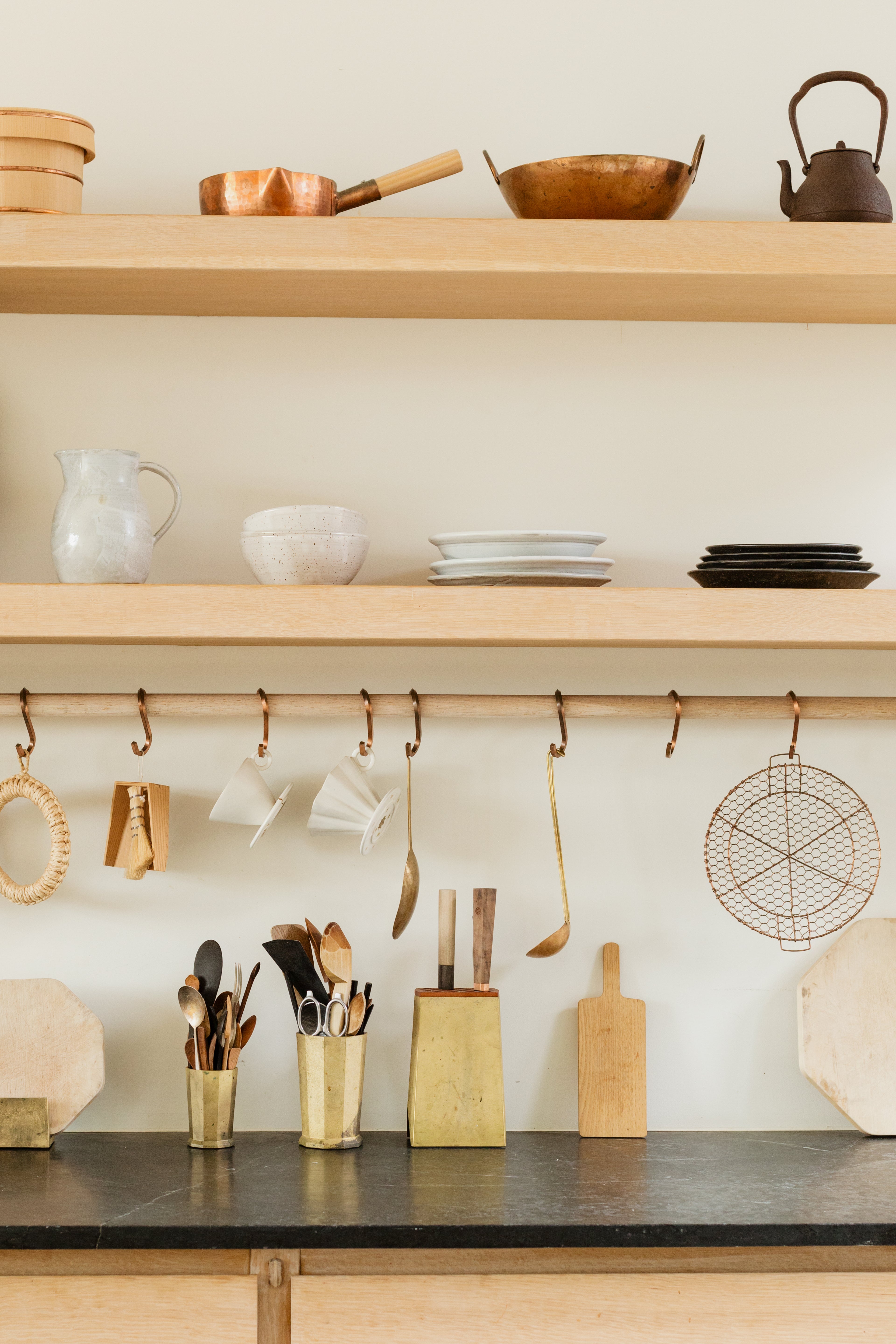 Fanned display of a variety of different wooden kitchen utensils