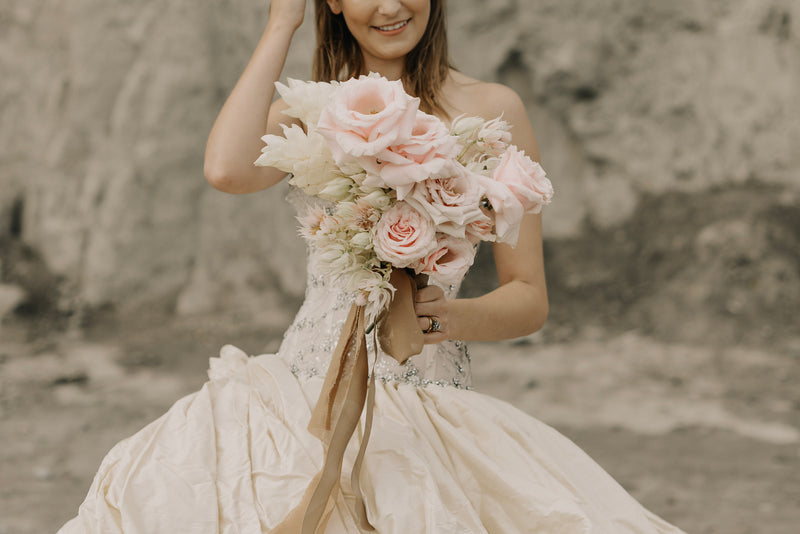 beautiful wedding bouquet and bride - a woman in a wedding dress holding a bouquet of flowers