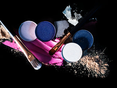 beauty products and makeup on black background