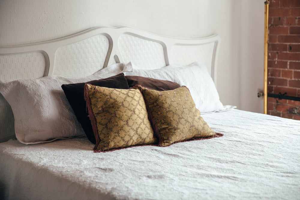 bedroom bed with brown throw pillows