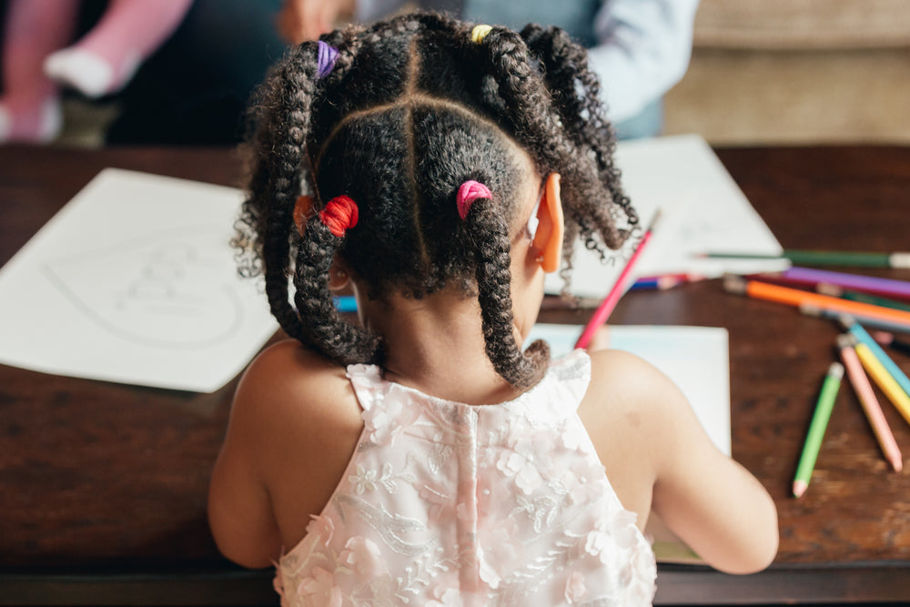 behind view of young girl drawing