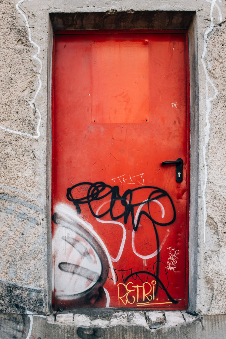 big-red-graffitied-door-in-concrete-wall