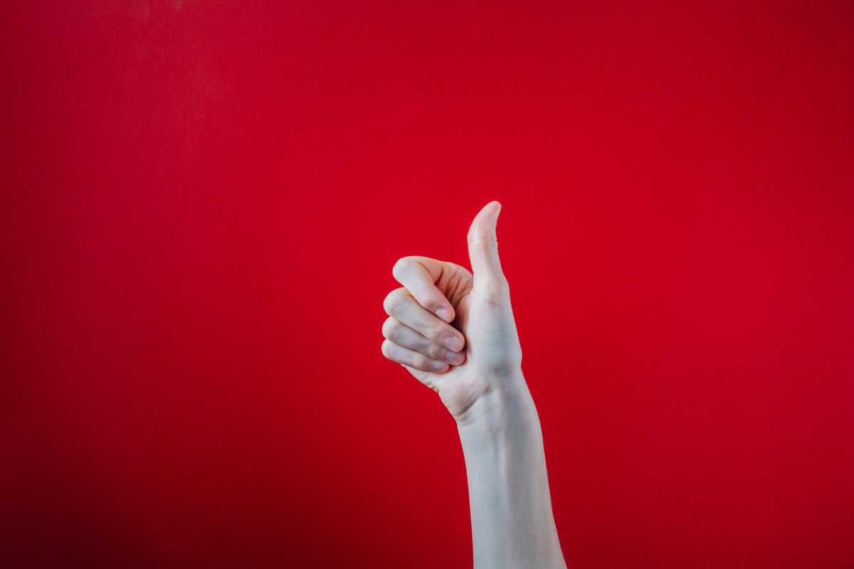 big thumbs up on red background