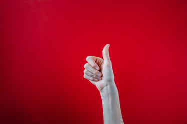 big thumbs up on red background