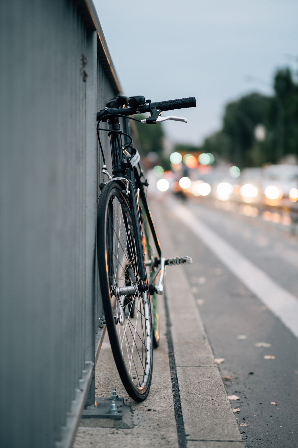 bike parked up by metal fence