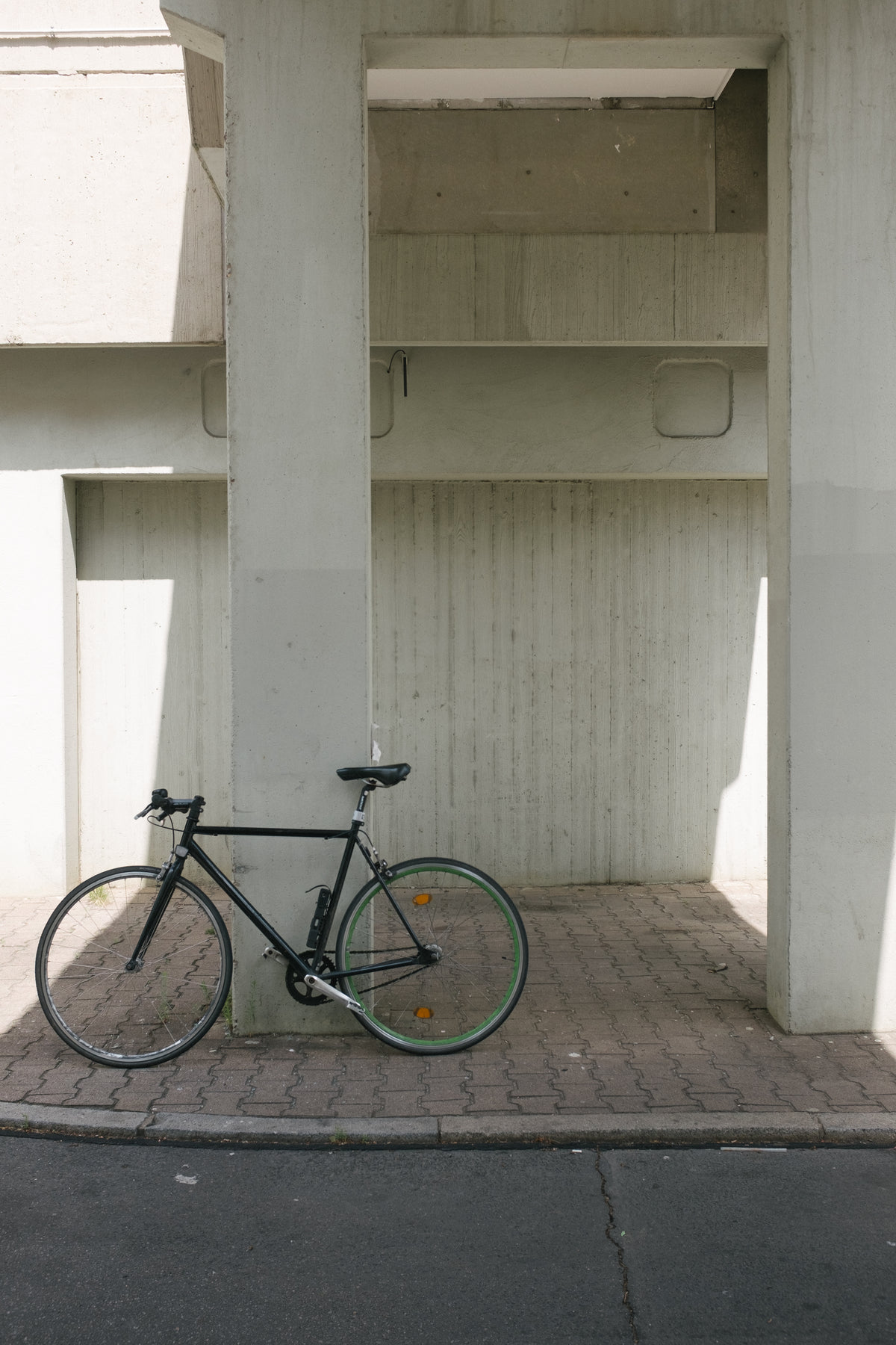bike sits against concrete column