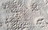 bird's-eye view of winter landscape carved by wind