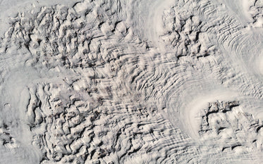 bird's-eye view of winter landscape carved by wind