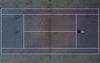 birds eye view of tennis courts with man