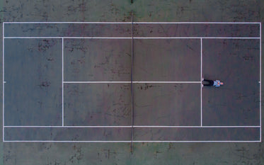 birds eye view of tennis courts with man