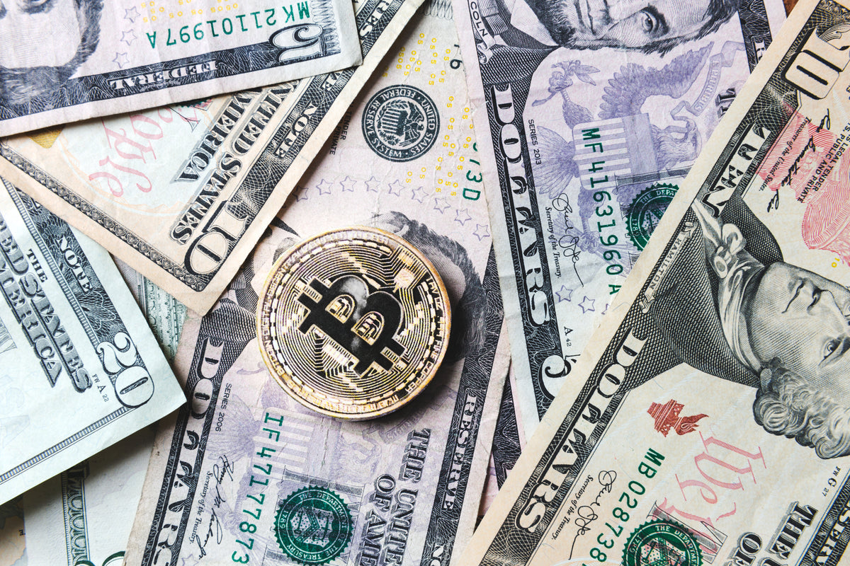 bitcoin coin on bills of cash money