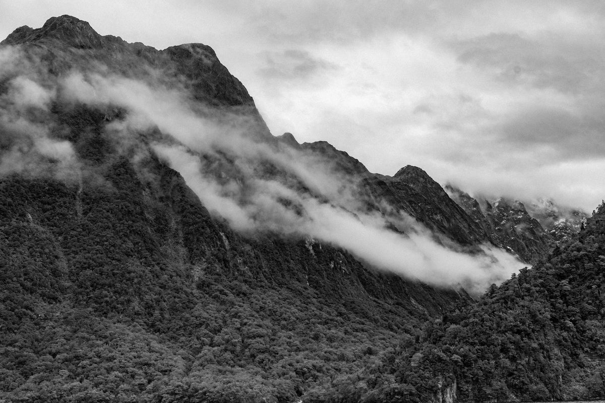 black and white image of mist over mountains