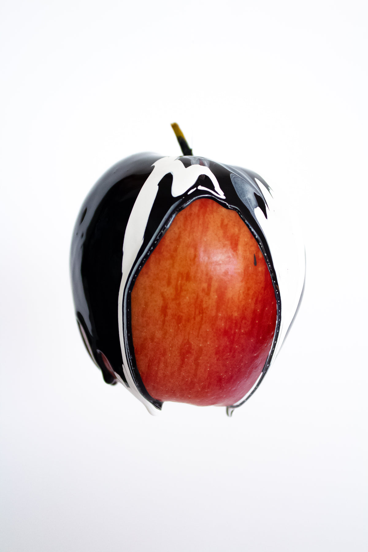 black and white paint on red apple