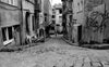 black and white photo of a narrow city street