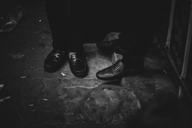 black and white photo of shoes outside